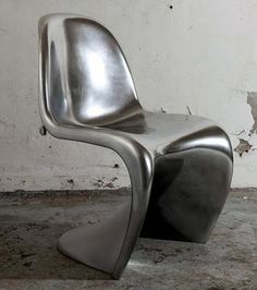 a modern chair sitting in front of a white wall