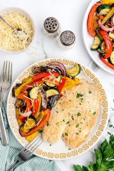 a white plate topped with chicken and veggies next to a bowl of pasta