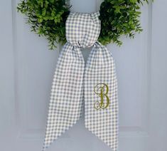 Welcome guest with this classic autumn blue plaid wreath sash personalized with your choice of monogram! This fall sash is made with 100% cotton designer fabric and measures approximately 5 inches x 52 inches. This wreath sash also makes an excellent gift!  Select your monogram font style and color. Please also include your single initial. I have many thread colors available. Please message me if you are looking for a specific hue. I look forward to working with you to design your custom wreath sash! Actual fabric and thread colors may vary. This is due to computer monitors and mobile devices displaying colors differently. Please message me if you need any samples. This listing is for a wreath sash only. Wreath and all other home decor items shown are not included. Thank you for visiting B Sash Ideas, Wreath Sash, Plaid Wreath, Autumn Blue, Coastal Wreath, Custom Wreath, Front Door Wreaths, Monogram Wreath, Thread Colors