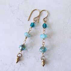 "Czech Blue Beachy Glass Linear Earrings on Brass 3\" Long." Blue Beaded Ear Wire Earrings For Summer, Blue Beaded Earrings With Ear Wire For Summer, Blue Ear Wire Earrings For The Beach, Blue Dangle Earrings For The Beach, Summer Light Blue Pierced Earrings, Blue Earrings For Vacation, Nickel Free Blue Earrings For Summer, Nickel-free Blue Earrings For Summer, Summer Blue Nickel-free Earrings