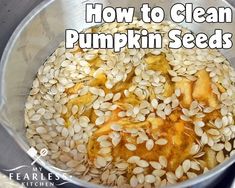 pumpkin seeds in a metal bowl with the words how to clean pumpkin seeds