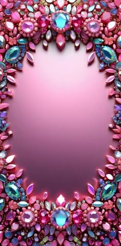 a pink and blue circular frame with lots of jewels on it's sides, in the center