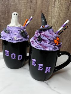 two black mugs with purple frosting and spooky witches on the top