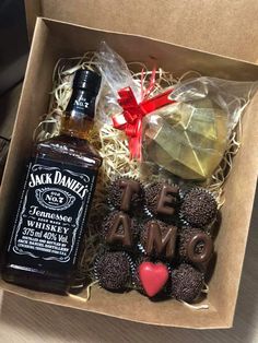 an open box with liquor, cookies and candies