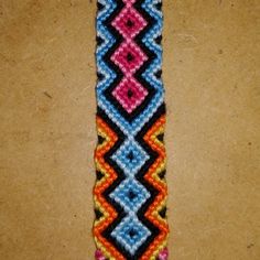 a multicolored beaded bracelet sitting on top of a table