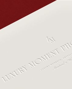 the luxury moment photo book is open on a red and white surface