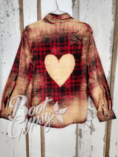 a red and black plaid shirt with a heart on it