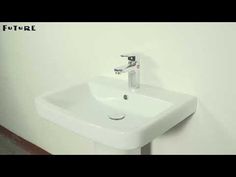 a white bathroom sink sitting on top of a counter next to a wall mounted faucet