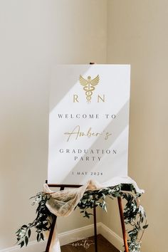 a welcome sign sitting on top of a wooden easel in front of a white wall