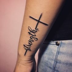 a woman with a cross tattoo on her arm