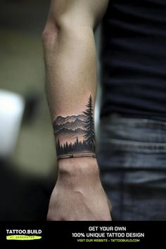 a man with a tattoo on his arm that has mountains and trees in the background