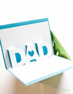 a father's day card with the word dad cut out from it in a box