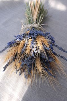 dried flowers are laying on a tablecloth in the sun, with grass sprouts sticking out of it