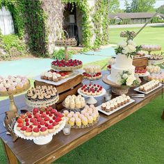 a table topped with lots of cakes and cupcakes