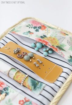 a close up of a tray with jewelry on it