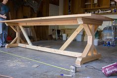 an image of a table being built in a garage with the words fancy x farmhouse house table on it