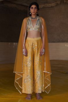 Ochre crop top with patchwork embroidered motifs. Paired with sequin embroidered flared pant and net dupatta.
Component: 3
Embroidered
Neckline: V neck
Sleeve Length: Sleeveless
Fabric: Chanderi,Net
Color: Yellow
Closure:
Crop Top: Back zip - Aza Fashions Saree Blouses Online, Yellow Pants, Embroidered Pants, Embroidered Neckline, Indian Fashion Designers, Pant Set, Embroidered Blouse, Pop Up Shop, Set Design