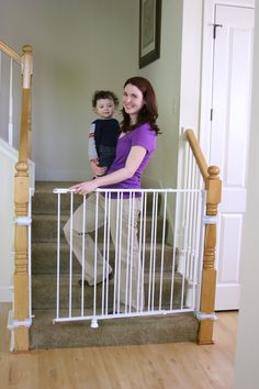 a woman and child standing at the bottom of stairs