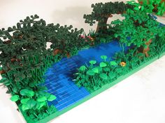 a lego model of a pond and trees