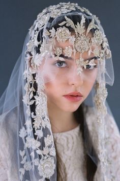 a woman wearing a veil with flowers on it