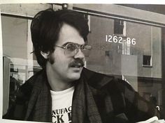 a man sitting in front of a window eating food