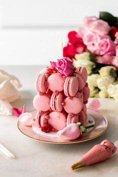 there is a cake made out of cookies on a plate with flowers in the background