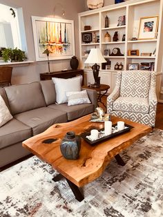 a living room with a couch, coffee table and bookshelf in the background