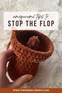 someone is holding an orange crocheted cup in their hand with the words, amigurn tips to stop the flop