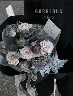 a bouquet of flowers sitting on top of a black box next to a street sign