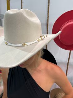 A timeless and on trend cowboy hat that’s crafted in a ivory faux suede with a coordinating band wrapped around. Meet the Dolly Cowboy Hat. The crown is stiffened and shaped into a clean and ridged design. Hand made by artisans, incredible quality, faux suede, lined with satin underneath. The best part? It's super structured with an elastic band on the inside that will fit EVERYONE. THE HAT:-Cowboy style hat, faux suede-Stiff brim with elastic hat band on the inside-- OMG YES-Gorgeous ivory-Hold Cream Cowboy Hat, Luxury High Crown Adjustable Hat Bands, Luxury Fedora For Kentucky Derby And Rodeo, Chic White Hat Bands For Kentucky Derby, Luxury Fedora For Rodeo And Kentucky Derby, Luxury Adjustable Hat Bands For Kentucky Derby, White Hats For Western-themed Events, Elegant White Hat Bands For Rodeo, Elegant White Hat Band For Rodeo