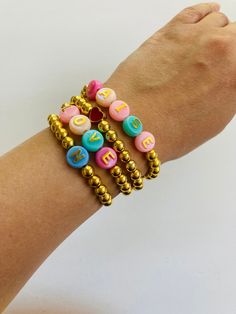 This Bracelet made up of Golden and color beads . Stretchy thread make it easy to wear. It's perfect gift  Shipped with USPS First Class Package. CLICK THE BELOW LINK FOR MORE DESIGNS https://www.etsy.com/shop/MindblowingDesigns?ref=seller-platform-mcnav§ion_id=50230132 Multicolor Friendship Bracelets With Spacer Beads As Gift, Colorful Beaded Bracelets With Spacer Beads As Gift, Cute Handmade Gold Beaded Bracelets, Handmade Gold Friendship Bracelets For Birthday, Gold Friendship Bracelets With Letter Beads For Valentine's Day, Valentine's Day Gold Friendship Bracelets With Letter Beads, Adjustable Beaded Bracelets With Heart Beads For Birthday, Colorful Bracelets With Spacer Beads For Gifts, Colorful Bracelets With Spacer Beads As Gift