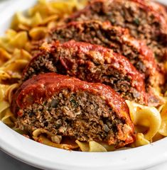 meatloaf stuffed with sauce and pasta in a white bowl