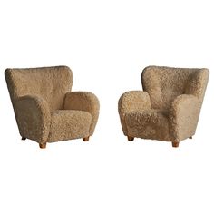 two chairs made out of sheepskin sitting next to each other