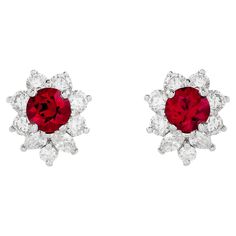 Illuminate your style with the captivating brilliance of Tiffany & Co.'s bright red ruby earrings. Set in platinum, these exquisite gems are embraced by a sparkling diamond halo, evoking a timeless elegance that exudes sheer sophistication. The two red rubies are round shape, and weigh approximately 1.20 total carats. There are 4 marquise and 14 round diamonds that surround the rubies; they weigh approximately 1.00 total carat and are E-F color with VS clarity. They are stamped "© Tiffany & Co. Tiffany And Co Earrings Bloomingdale's, Luxury Ruby Diamond Earrings For Anniversary, Red Diamond Earrings, Tiffany And Co Earrings, Red Ruby Earrings, Ruby Earrings Studs, Halo Stud Earrings, Tiffany Jewelry, Halo Earrings Studs