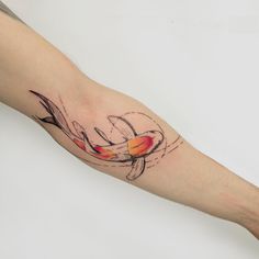 a person's arm with a fish tattoo on it