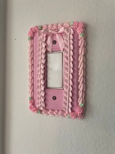 a pink light switch cover with a bow on it