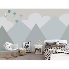 a bedroom with mountains and hot air balloons painted on the wall, along with a bed