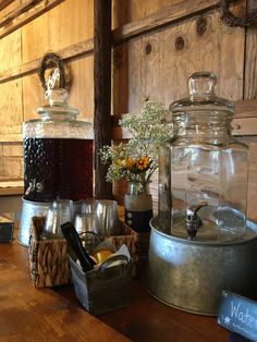 there are two glass jars with drinks in them on the table next to each other