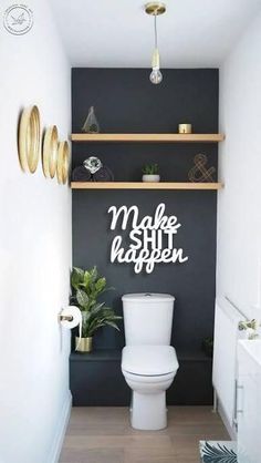 a white toilet sitting in a bathroom next to a wooden shelf filled with potted plants