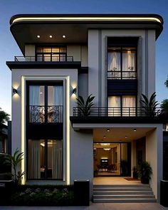 a large white house with lots of windows and balconies on the second floor