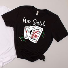 two t - shirts sitting next to each other on top of a white and black surface