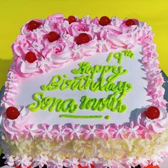 a birthday cake with pink and white frosting