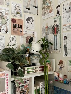 a room with many posters and plants on the wall