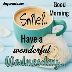 a cup of coffee sitting on top of a table next to a flower and the words smile have a wonderful wednesday