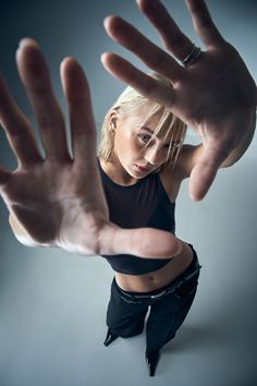 a woman in black shirt holding her hands out