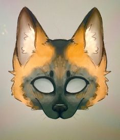 a cat mask is shown in the shape of a fox's head with eyes