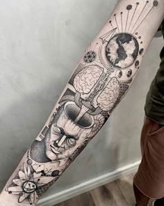 a man's arm with an abstract tattoo on it