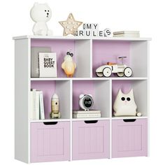 a white and pink book shelf filled with toys