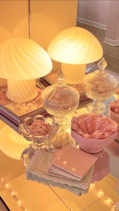 a table topped with lots of different types of food on top of glass plates and bowls