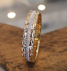 two wedding rings sitting on top of a wooden table